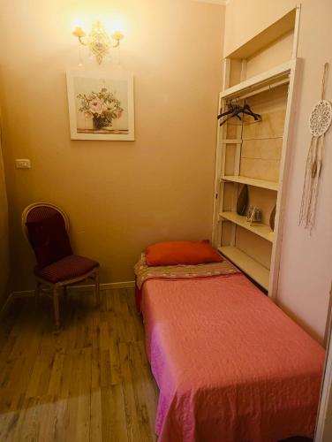 a room with two beds and a chair in it at Love Gioia Tauro in Gioia Tauro