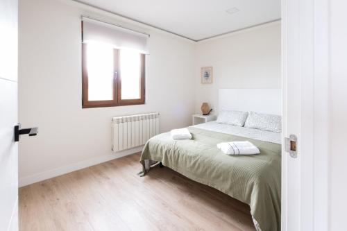 Ένα ή περισσότερα κρεβάτια σε δωμάτιο στο Arena - El Silencio Apartamentos