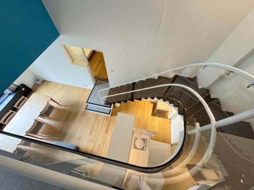 a glass staircase in a house with a room at 星野度假村Village Alpha Tomamu复式公寓套房 in Tomamu