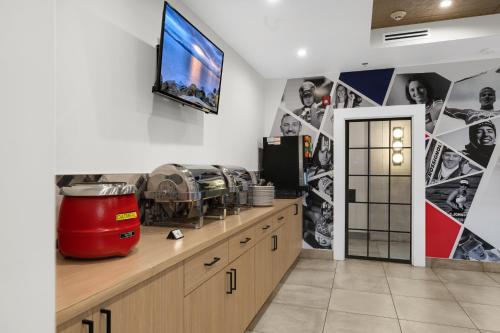 a kitchen with a tv on the wall at Lake Placid Inn Boutique Hotel in Lake Placid