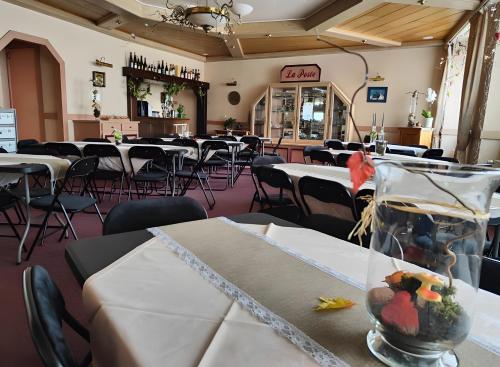 a dining room with tables and chairs in a restaurant at Chambres D'hôtes in Bains-les-Bains