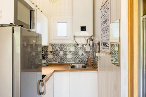 a small kitchen with a sink and a refrigerator at Lodge Natura in Ambérieu-en-Bugey