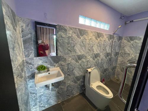 a bathroom with a toilet and a sink at Top View Kohrong in Koh Rong
