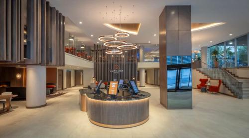 a lobby with a large chandelier in a building at Clayton Hotel Cardiff Lane in Dublin