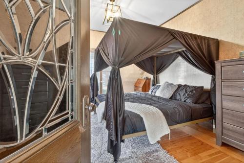 a bedroom with a bed with a canopy at Heritage House Downtown Moncton in Moncton
