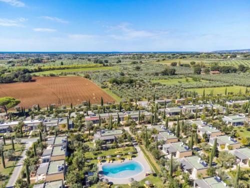 an aerial view of a resort with a pool and palm trees at Hotiday Lodge Cecina in Cecina