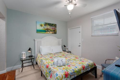 a bedroom with a bed with a colorful bedspread at Clearwater Beach Suites #106 in Clearwater Beach