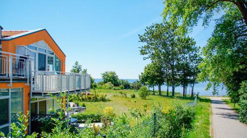 an orange house with a view of a yard at Residenz Meeresblick B Fewo 4 in Rerik