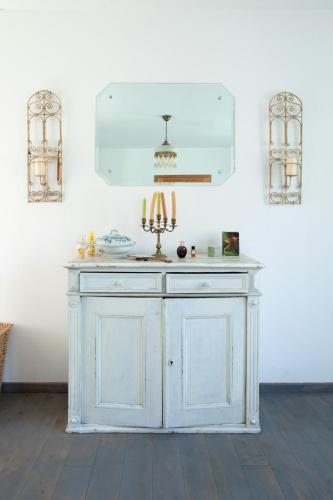 a white cabinet with a candle on it in a room at Idyllic Home Between Fields And Elbe Dyke in Eickerhöfe