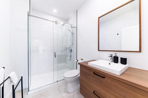 a bathroom with a shower and a toilet and a sink at Havre du Loup: St. Lawrence River Views & Trails in Petite-Rivière-Saint-François