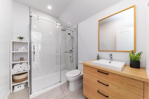 a bathroom with a shower and a toilet and a sink at Flocon Marin 1229 in Petite-Rivière-Saint-François