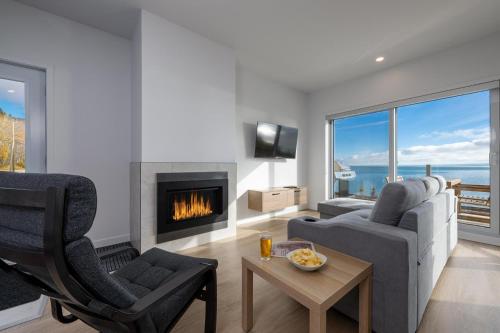 a living room with a couch and a fireplace at Panorama 1251: Private & Luxury, River Sunsets in Petite-Rivière-Saint-François