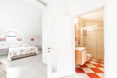 a white bedroom with a bed and a bathroom at Villa Garden Island in Dalyan