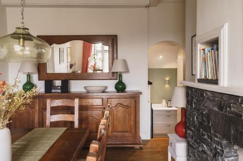 a dining room with a table and a mirror at 2 Hart Head Barn, Renovated Barn, Ambleside in Rydal