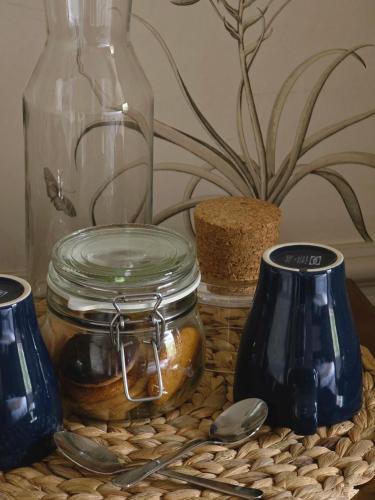 a table with two blue vases and a glass jar at Red Bull in Stockport