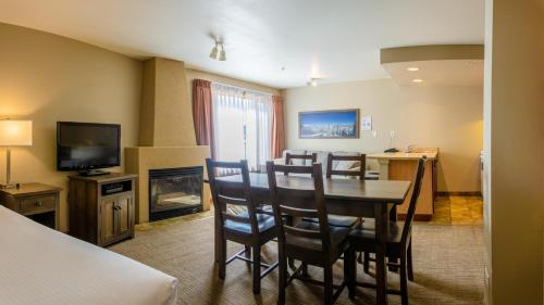 a dining room with a table and chairs and a television at Cahilty #346 home in Sun Peaks