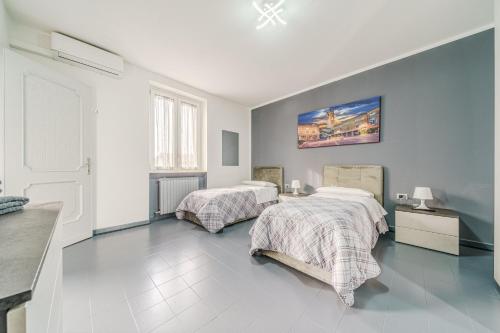 a bedroom with two beds and a wall at Casa Francesco - close to the airport & private parking in Azzano San Paolo