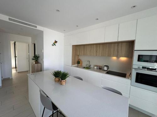 a kitchen with white cabinets and a white counter top at Villa in Rojales in Rojales