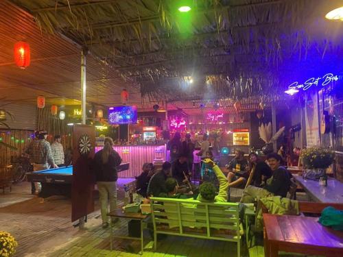 a group of people sitting in a bar with a pool table at Trang xinh homestay Tam coc 