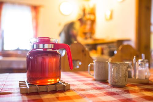 a jug of tea sitting on a table at Penzion pod Šerákem in Ostružná