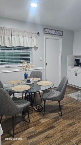 a dining room with tables and chairs and a kitchen at Newly remodeled Near Midtown S Tampa Westshore in Tampa