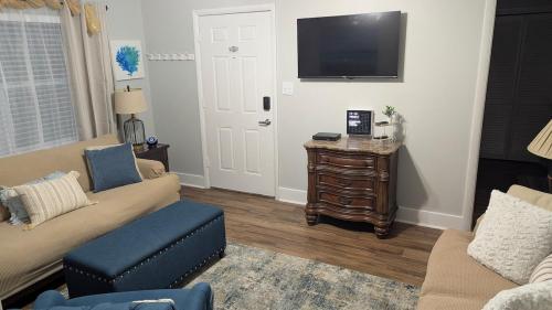 a living room with a couch and a tv at Newly remodeled Near Midtown S Tampa Westshore in Tampa