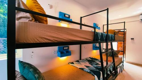 a bedroom with two bunk beds in a room at Mitra Palolem in Canacona