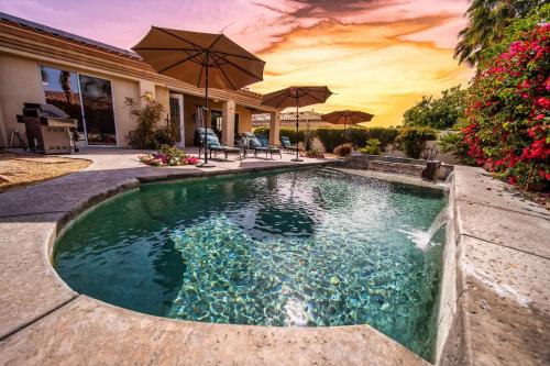 a swimming pool in the middle of a house at Luxurious Custom-built Villa Pool Spa Fire Pit more in Palm Desert
