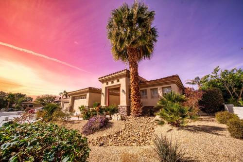 a palm tree in front of a house at Luxurious Custom-built Villa Pool Spa Fire Pit more in Palm Desert