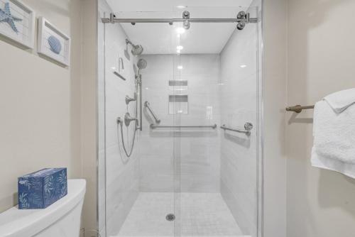a shower with a glass door in a bathroom at Island Beach Club #320E in Sanibel