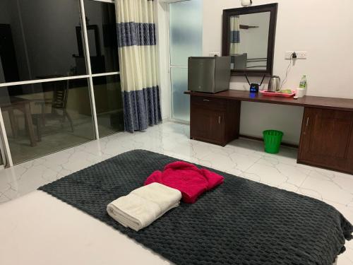 a pile of towels on a rug in a bathroom at Sevenra Grand Beach Hotel in Ambalangoda