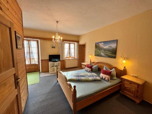 a bedroom with a large bed in a room at Pension Huber in Fischbachau