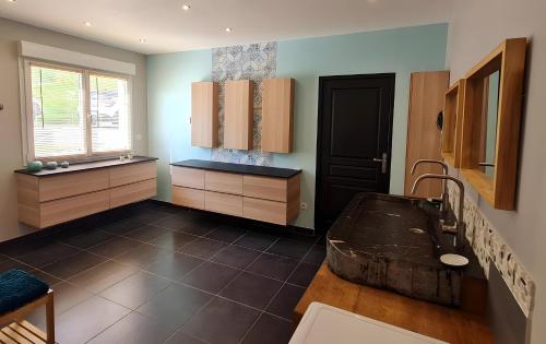 a large kitchen with a sink and a window at Villa des ermites in Favières