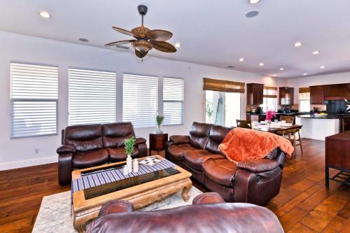 a living room with leather couches and a table at Poolside Bliss with elegant living #1 Rated in Palm Desert