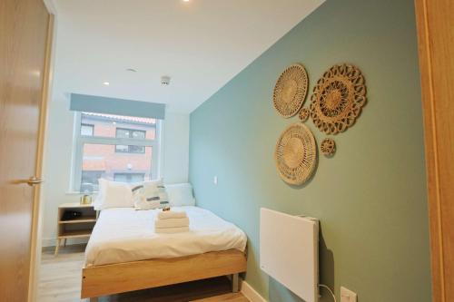 a bedroom with a bed and plates on the wall at Studio Flat Close to Queen Square - Flat 4A in Bristol