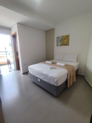 a bedroom with a large bed in a room at Suíte 12 dupla com vista para o mar in Pontal do Paraná