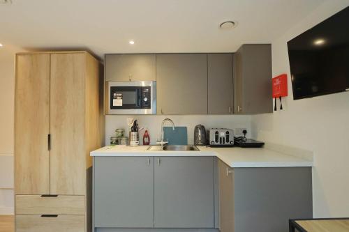 a kitchen with a sink and a microwave at Studio Flat Close to Queen Square - Flat 5B in Bristol