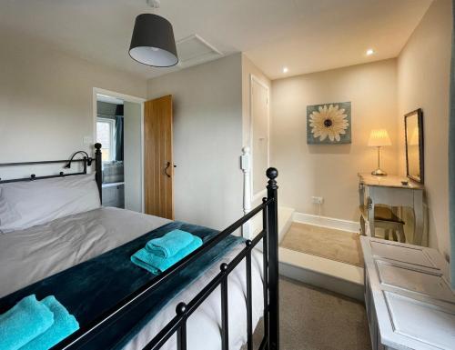 a bedroom with a bed and a bath tub at Tyg Cottage in Grewelthorpe