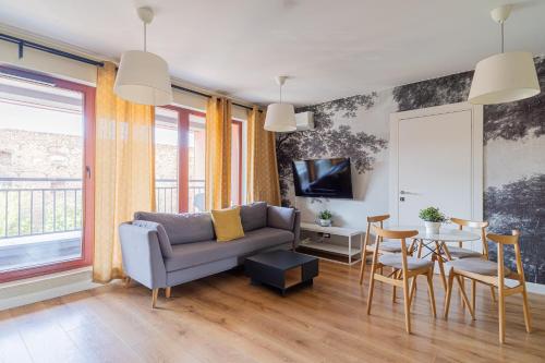 a living room with a couch and a table at SPA Waterlane Island Deluxe 1 by Grand Apartments in Gdańsk