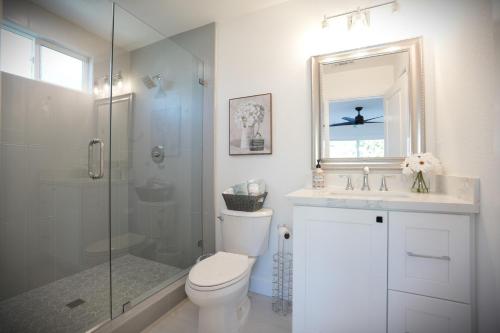 a bathroom with a shower and a toilet and a sink at Destination #47 in Orange