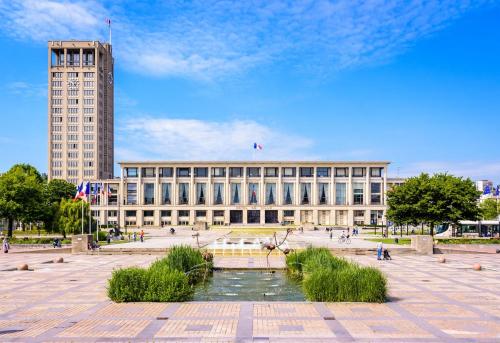 a large building with a fountain in front of it at The suspended cocoon in Le Havre