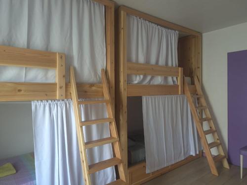 two sets of bunk beds in a room at Pés Verdes-Alojamento e Chá in Ponta Delgada