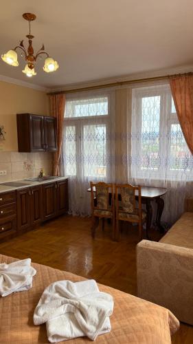 a kitchen with a table and a dining room at Hercules in Truskavets
