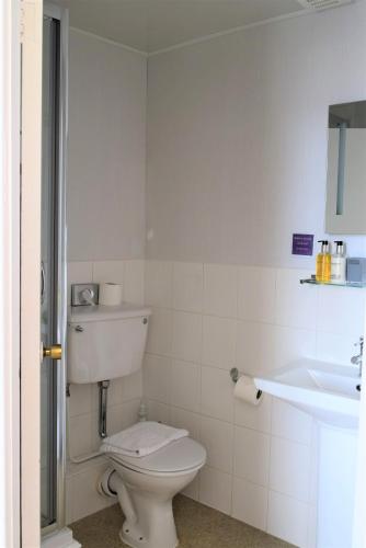 a bathroom with a toilet and a sink at The View Guest House (Adults Only) in Llandudno