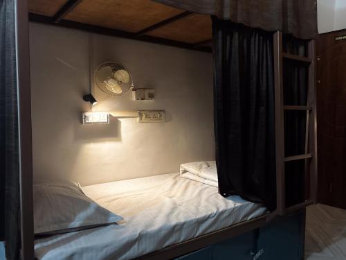 a bedroom with a bunk bed and a ladder at Mosaic Hostel Varanasi in Varanasi