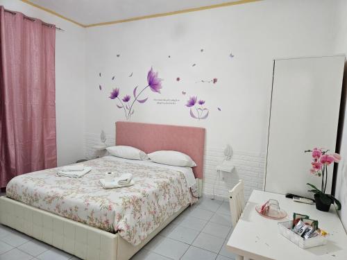 Ένα ή περισσότερα κρεβάτια σε δωμάτιο στο Le tre orchidee