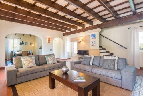 a living room with two couches and a coffee table at Villa Mig Coster - Refugio rural en finca privada in Sant Lluis