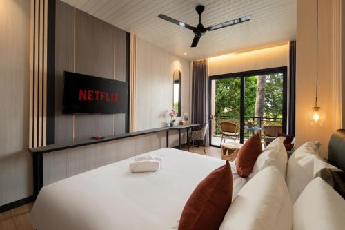 a hotel room with a bed and a view of a patio at Amankara Canggu in Canggu