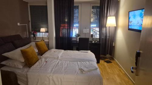 a hotel room with a bed and a television at Hotell Västerås in Västerås