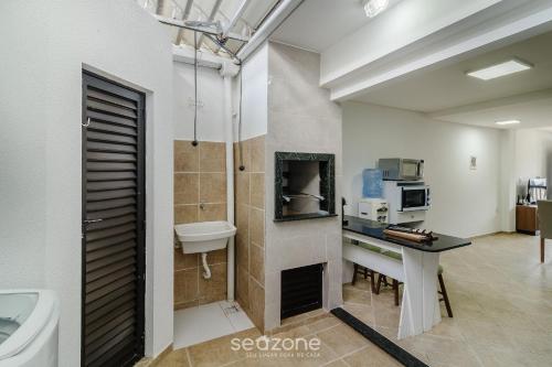 a bathroom with a sink and a toilet and a sink at Casas em condomínio a Beira-Mar com piscina, Itajubá - MCSs in Itajubá